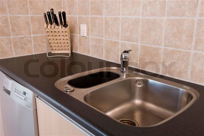 Kitchen sink and block of knives, stock photo