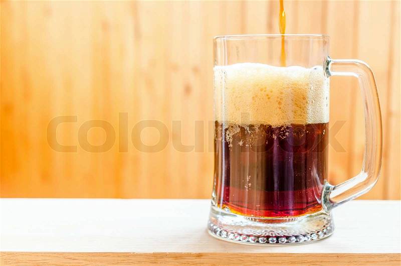 Beer pouring into mug, stock photo