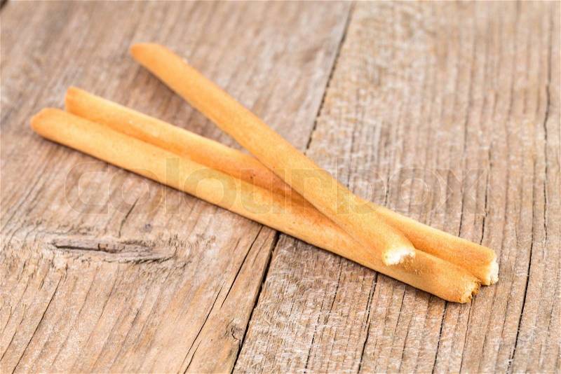 Bread sticks grissini on rustic wooden background, stock photo