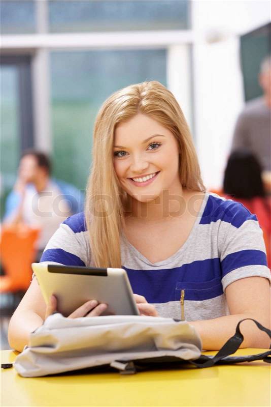 Female Teenage Student In Classroom With Digital Tablet, stock photo