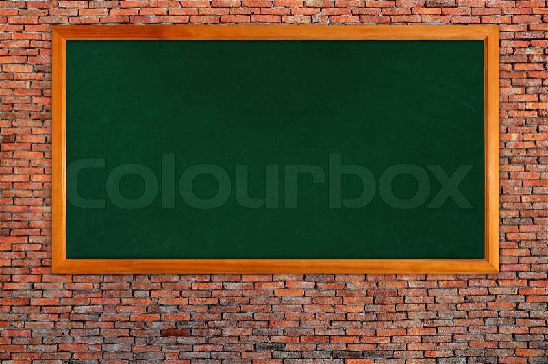 Blackboard on brick wall, stock photo