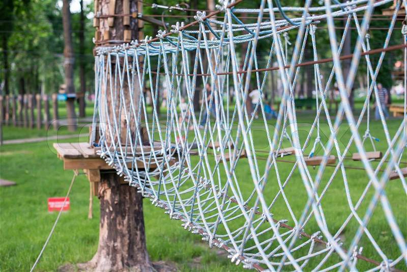 The bridge of logs tied to the ropes, part of a ropes course, stock photo