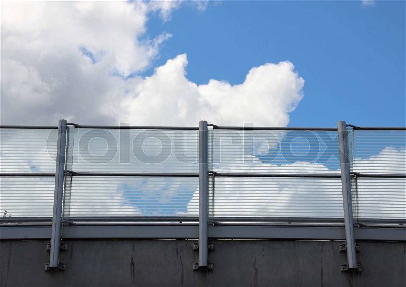 Metal and glass railing with blue sky horizontal, stock photo