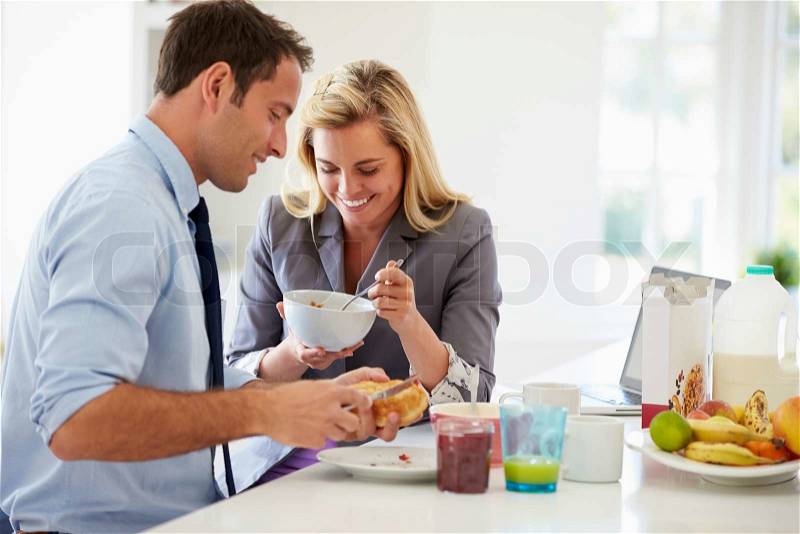 Couple Having Breakfast Together Before Leaving For Work, stock photo