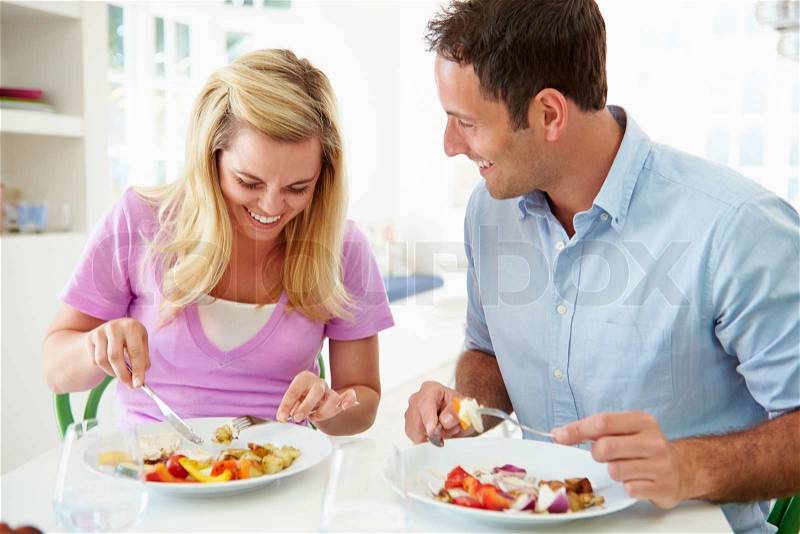 Couple Eating Meal At Home Together, stock photo