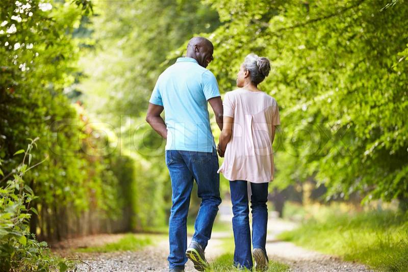 Mature African American Couple Walking In Countryside, stock photo