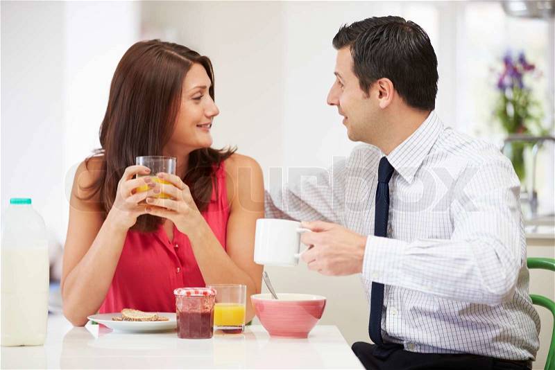 Couple Having Breakfast Before Husband Goes To Work, stock photo