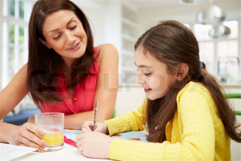 Mother Helping Daughter With Homework, stock photo