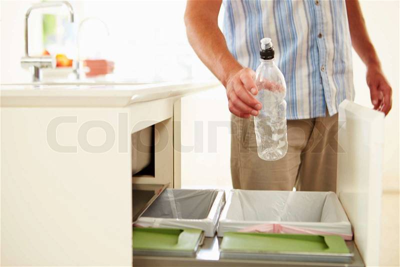 Close Up Of Man Recycling Kitchen Waste In Bin, stock photo