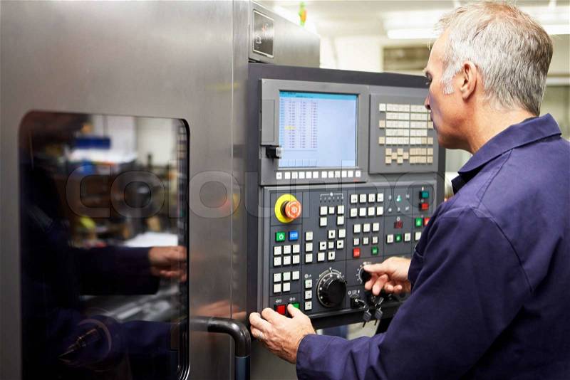Engineer Operating Computer Controlled Lathe, stock photo