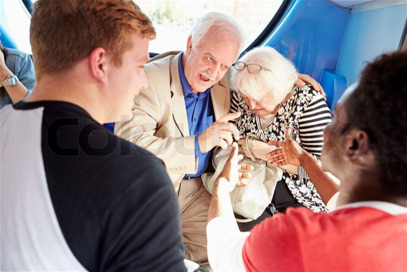 Senior Couple Being Harassed On Bus Journey, stock photo