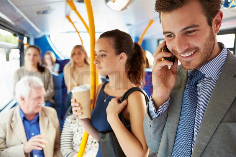 Passengers Standing On Busy Commuter Bus, stock photo