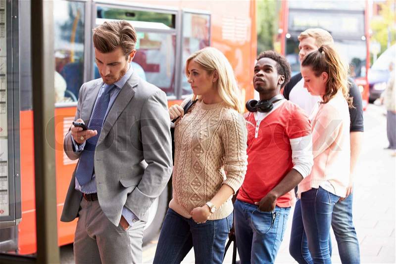 Queue Of People Waiting At Bus Stop, stock photo