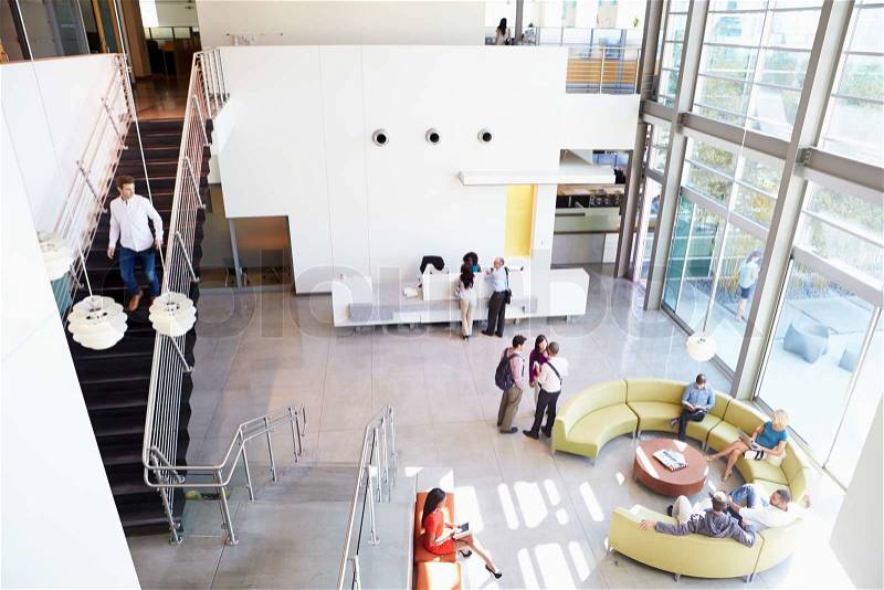 Reception Area Of Modern Office Building With People, stock photo