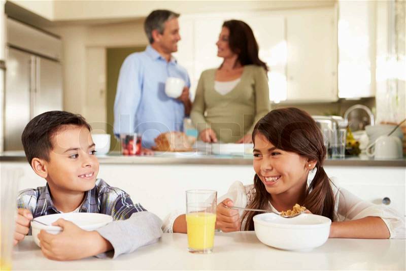Hispanic Family Eating Breakfast At Home Together, stock photo