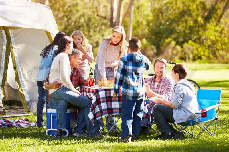 Two Families Enjoying Camping Holiday In Countryside, stock photo
