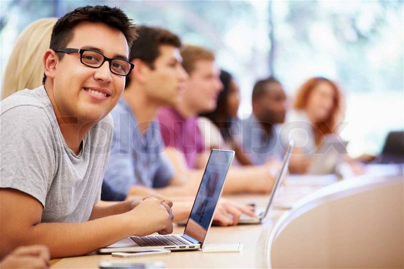 Class Of University Students Using Laptops In Lecture, stock photo