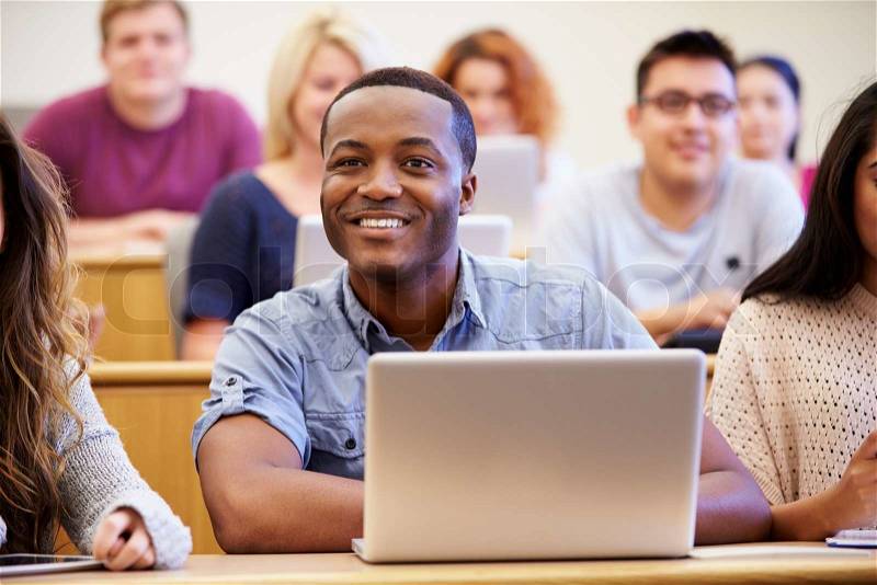Male University Student Using Laptop In Lecture, stock photo