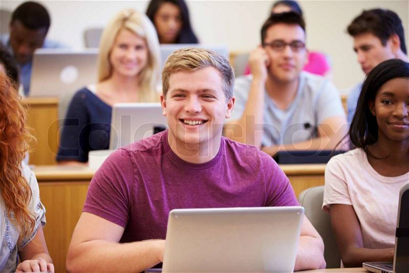 Male University Student Using Laptop In Lecture, stock photo