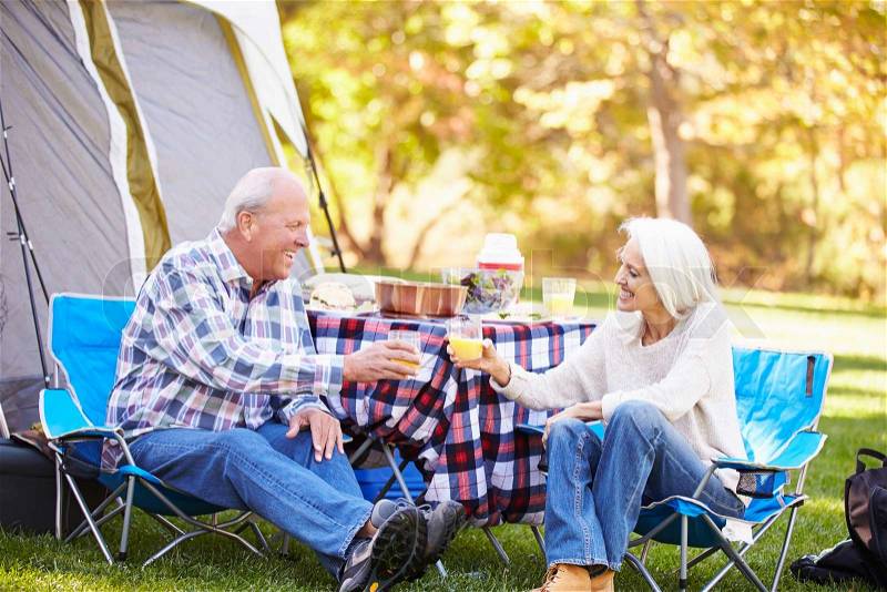 Senior Couple Enjoying Camping Holiday In Countryside, stock photo