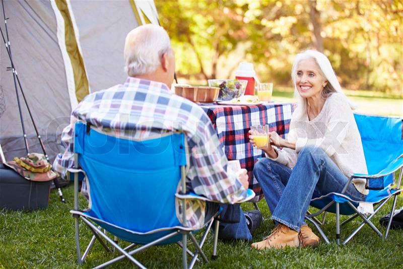 Senior Couple Enjoying Camping Holiday In Countryside, stock photo
