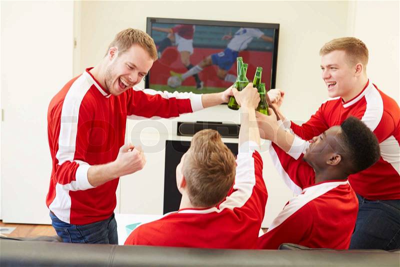 Group Of Sports Fans Watching Game On TV At Home, stock photo