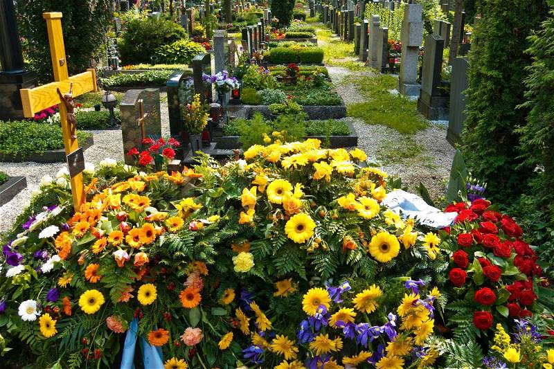 In a cemetery, a fresh grave is for a funeral, stock photo
