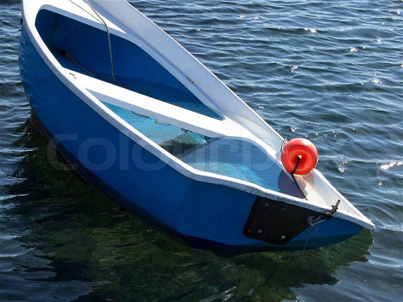 Small plastic boat sinking after storm, stock photo