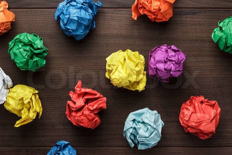 Crumpled colorful paper on wooden background creative process, stock photo