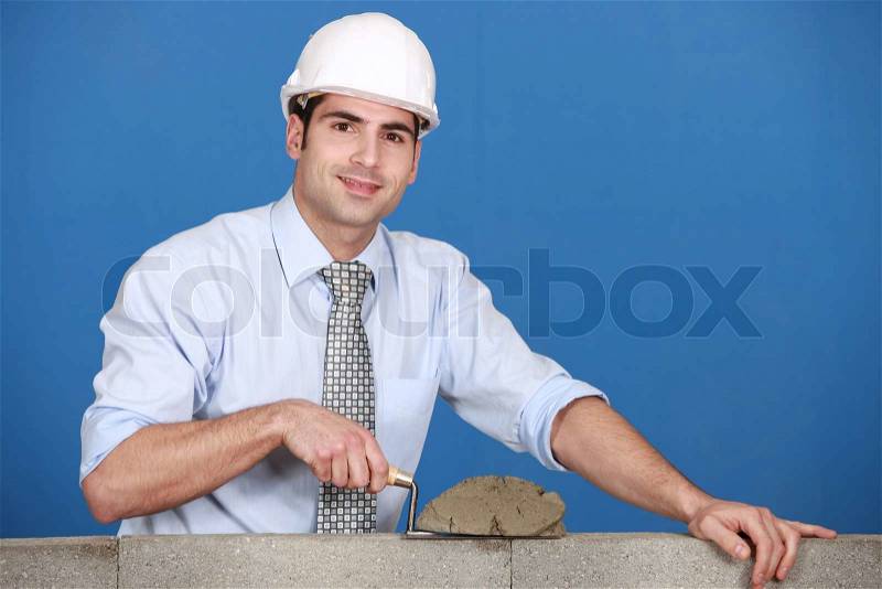 Architect laying a block, stock photo