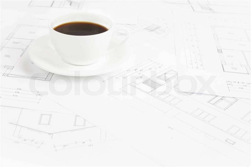Architectural office desk with blueprints and coffe cup, stock photo
