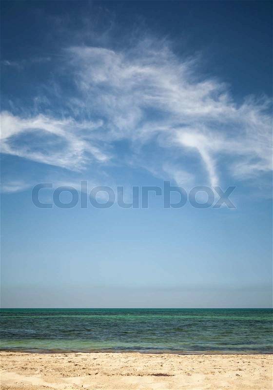 Beautiful cloudy sky over white sandy beach. Vertical photo background, stock photo