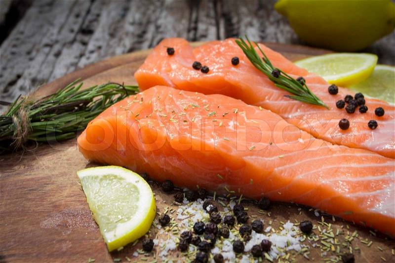 Close up Fresh salmon with spices on old wood , stock photo