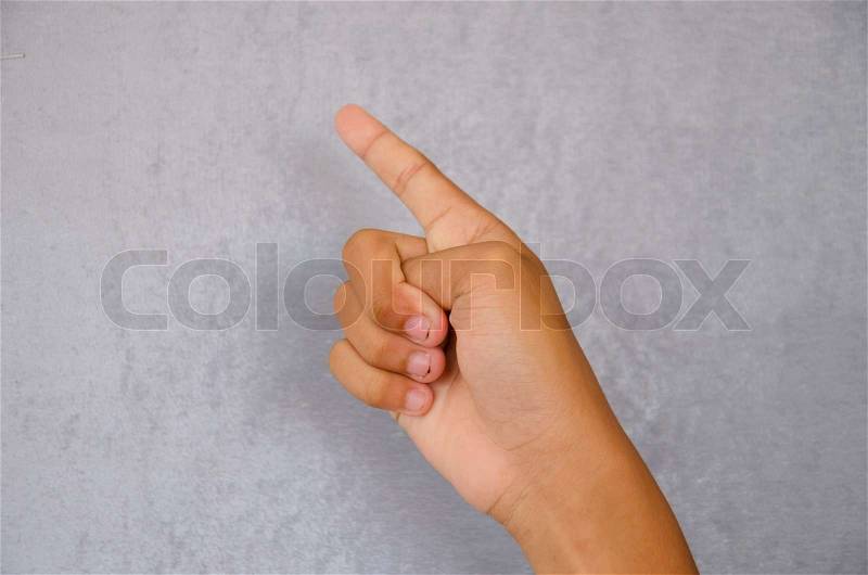 Children point finger on gray background, stock photo