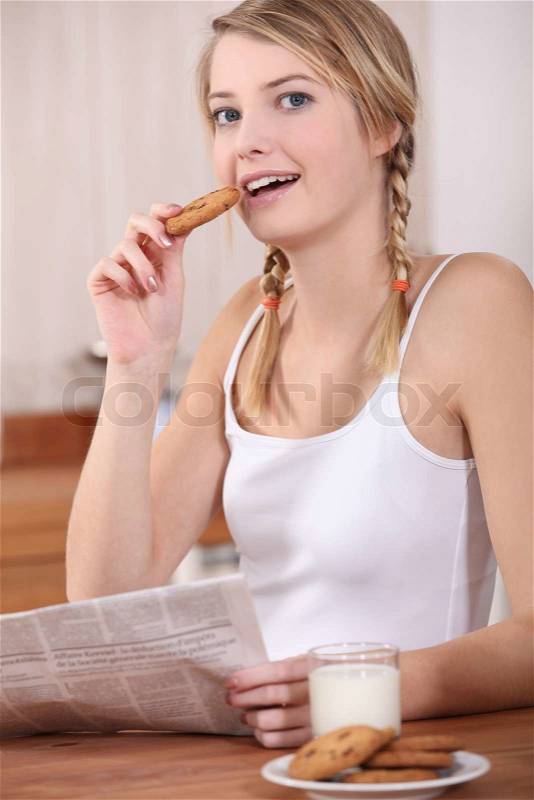 Woman having breakfast before work, stock photo