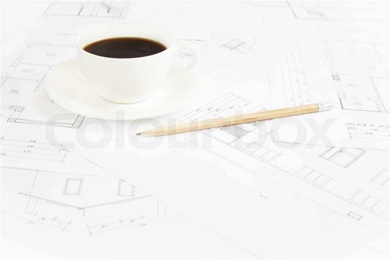 Architectural office desk with blueprints and coffe cup, stock photo