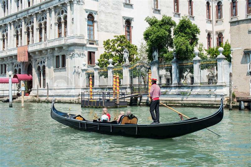 Ancient buildings and boats in the channel in Venice. Gondolier, stock photo