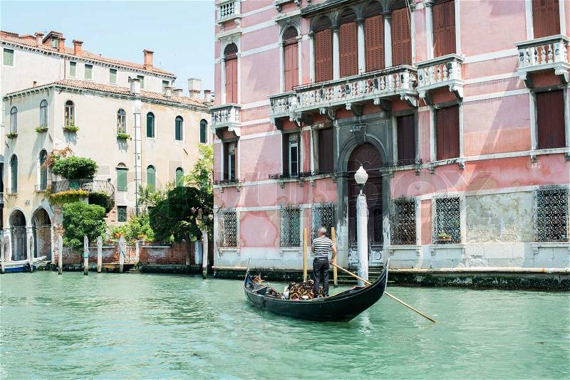 Ancient buildings and boats in the channel in Venice, stock photo