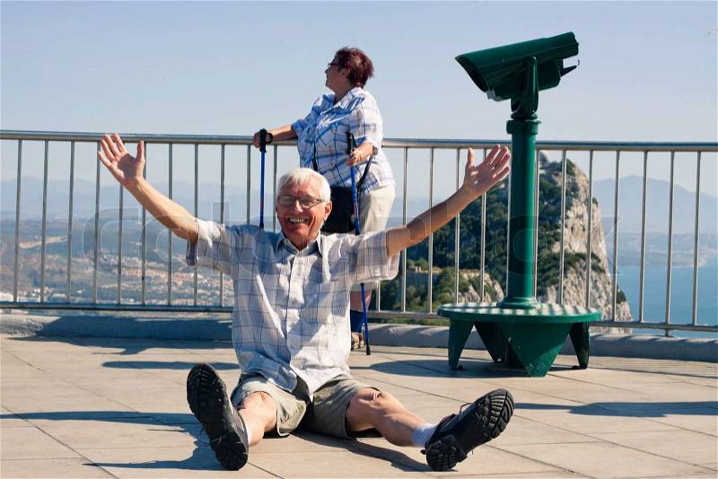 [Image: 10343652-hilarious-senior-man-tourist-on...r-rock.jpg]
