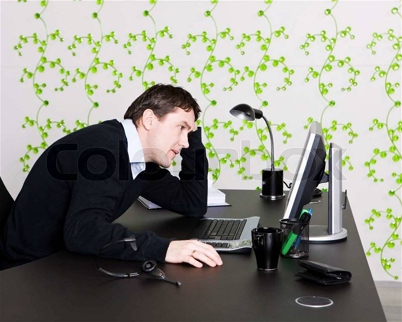 Man frustrated in front of his computer, stock photo