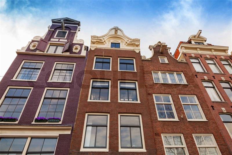Living houses facades with blue sky. Amsterdam, Netherlands, stock photo