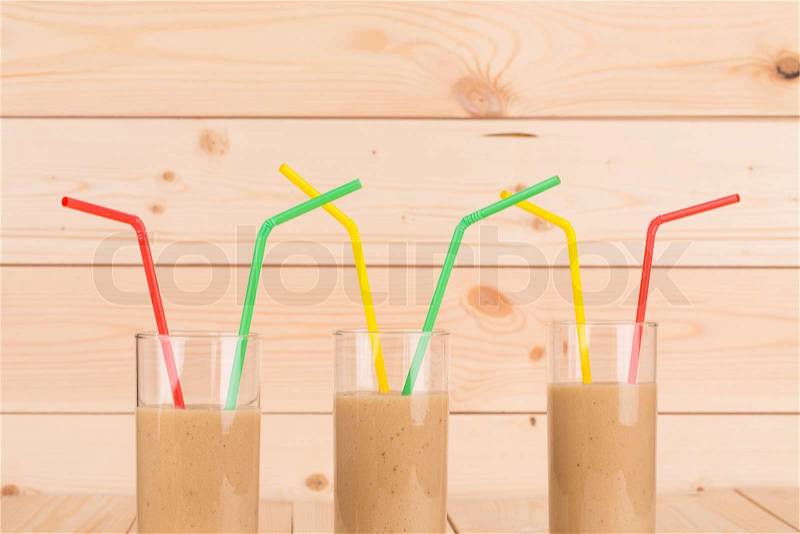Banana fresh juice with straw. Whole background, stock photo
