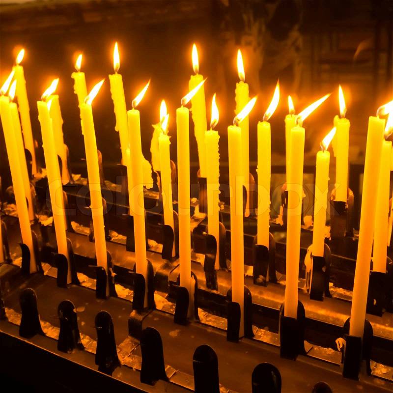 Church candle in a row. Closeup of burning candle, stock photo