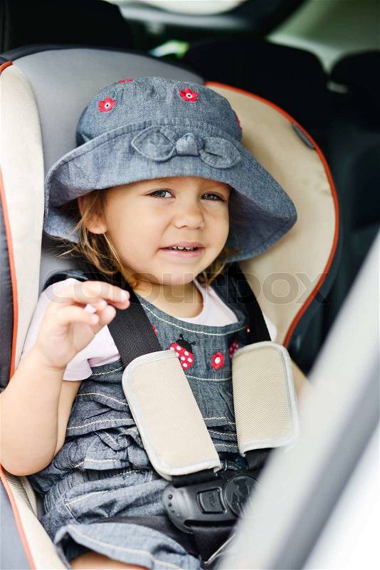 Happy toddler in the car seat, stock photo