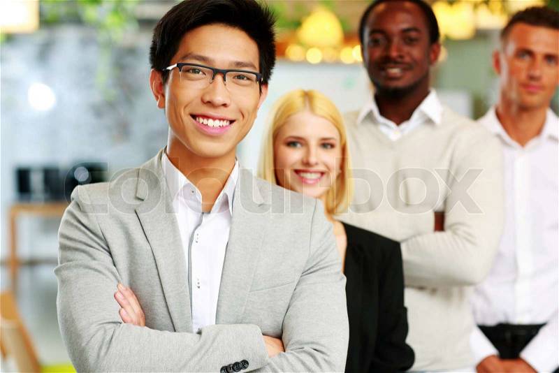 Cheerful group of business people in the office lined up, stock photo