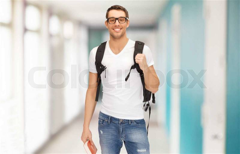 Education, travel and vacation concept - smiling student in eyeglasses with backpack and book, stock photo