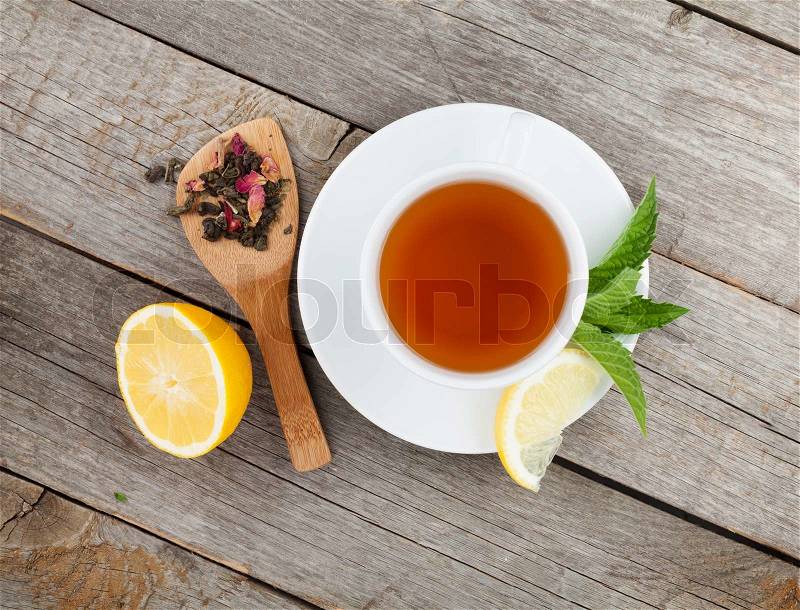 Green tea with lemon and mint on wooden table. View from above, stock photo