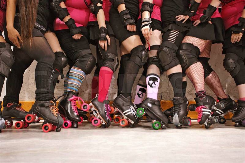 The roller skates and legs of a female Roller Derby team. Skull image on socks is from an image in my portfolio called Pile of Skulls, stock photo