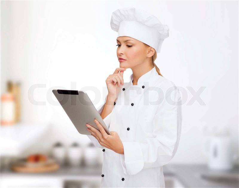 Cooking, technology and food concept - smiling female chef, cook or baker with tablet pc computer, stock photo