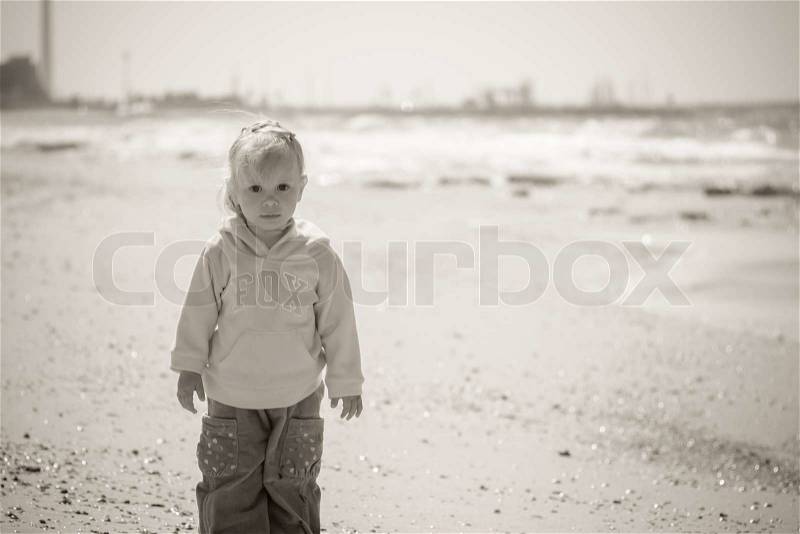 Little girl on sea, black and white photo, stock photo